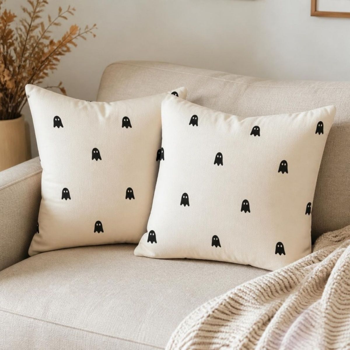 Two cream pillow covers with tiny black ghost faces