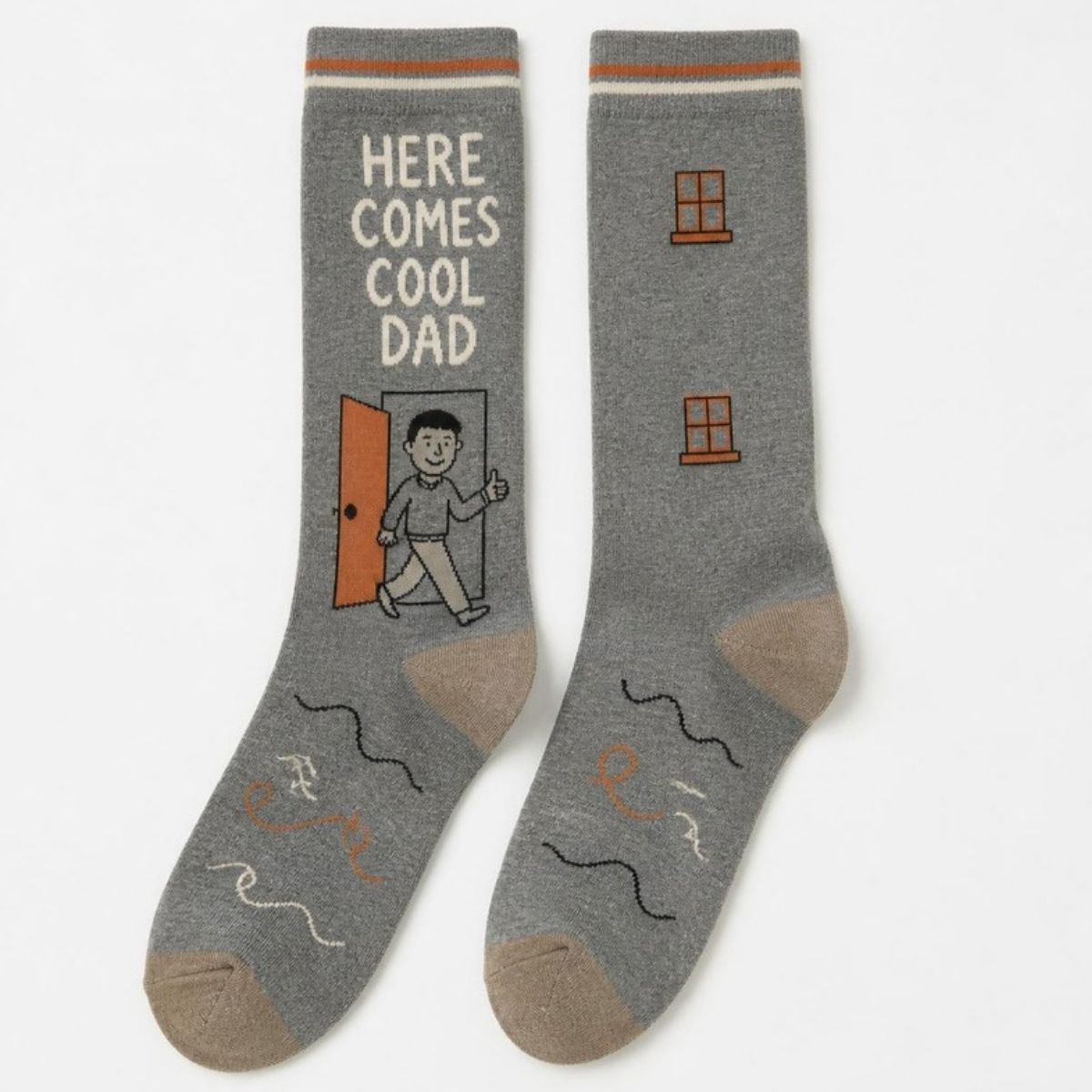 Gray crew socks reading "Here comes cool dad" with a doodle of a man walking out of an orange door