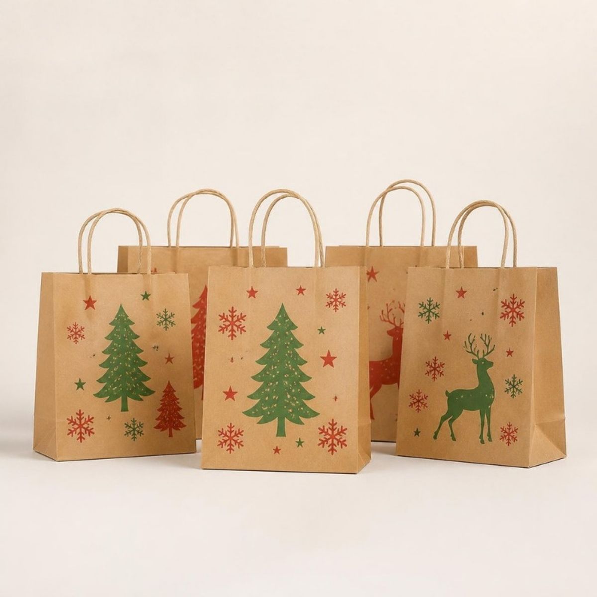 Brown kraft paper gift bags printed with Christmas trees, reindeer and snowflakes