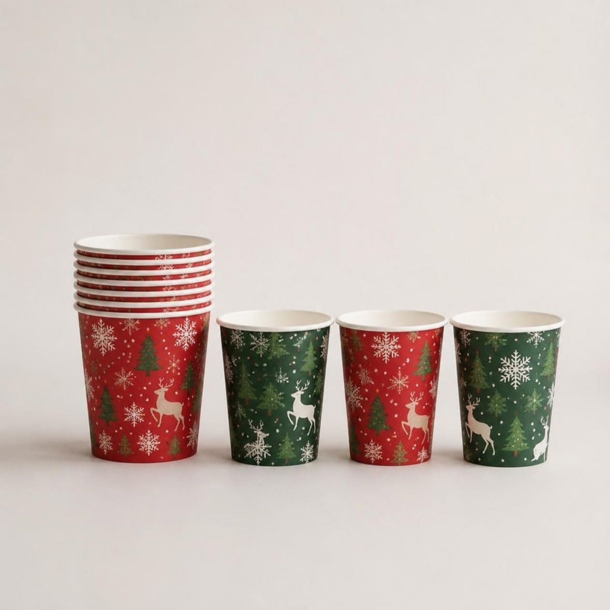 Red and green paper cups printed with reindeer, Christmas trees and snowflakes