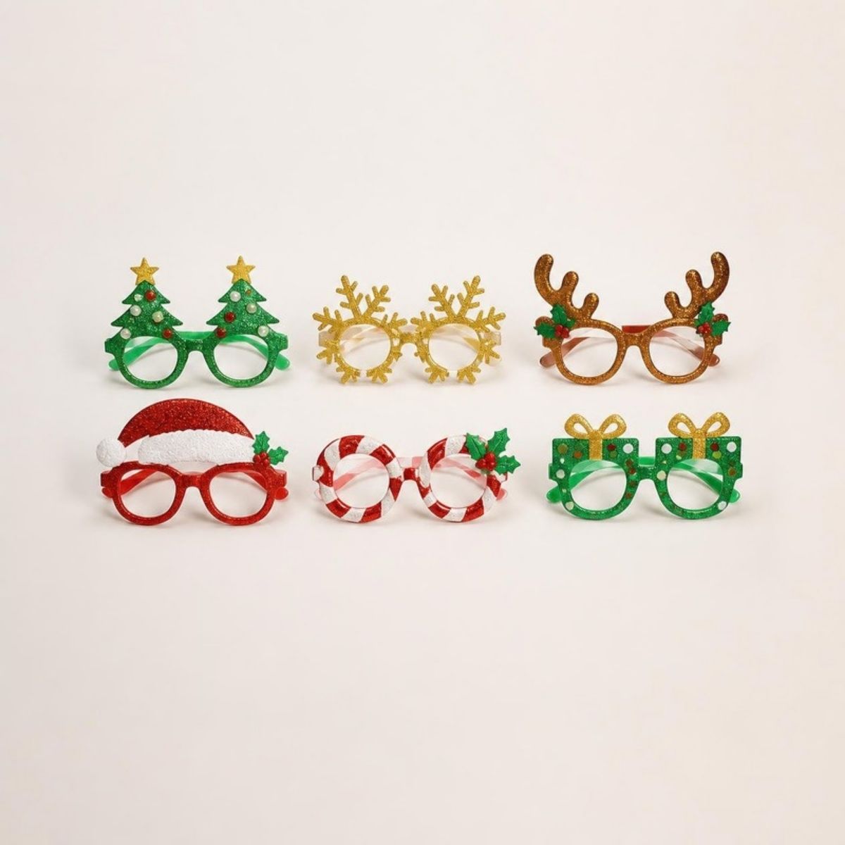 Six glittery Christmas party glasses shaped like trees, snowflakes, antlers, a Santa hat, candy canes and gifts