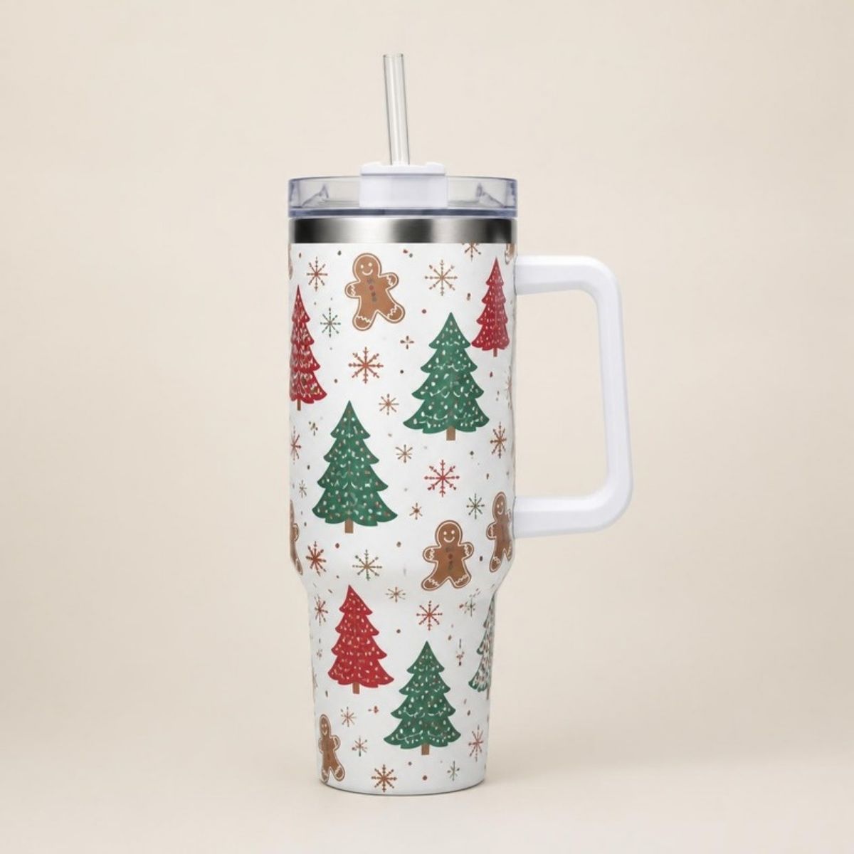 White tumbler with handle and straw printed with Christmas trees, gingerbread men and snowflakes