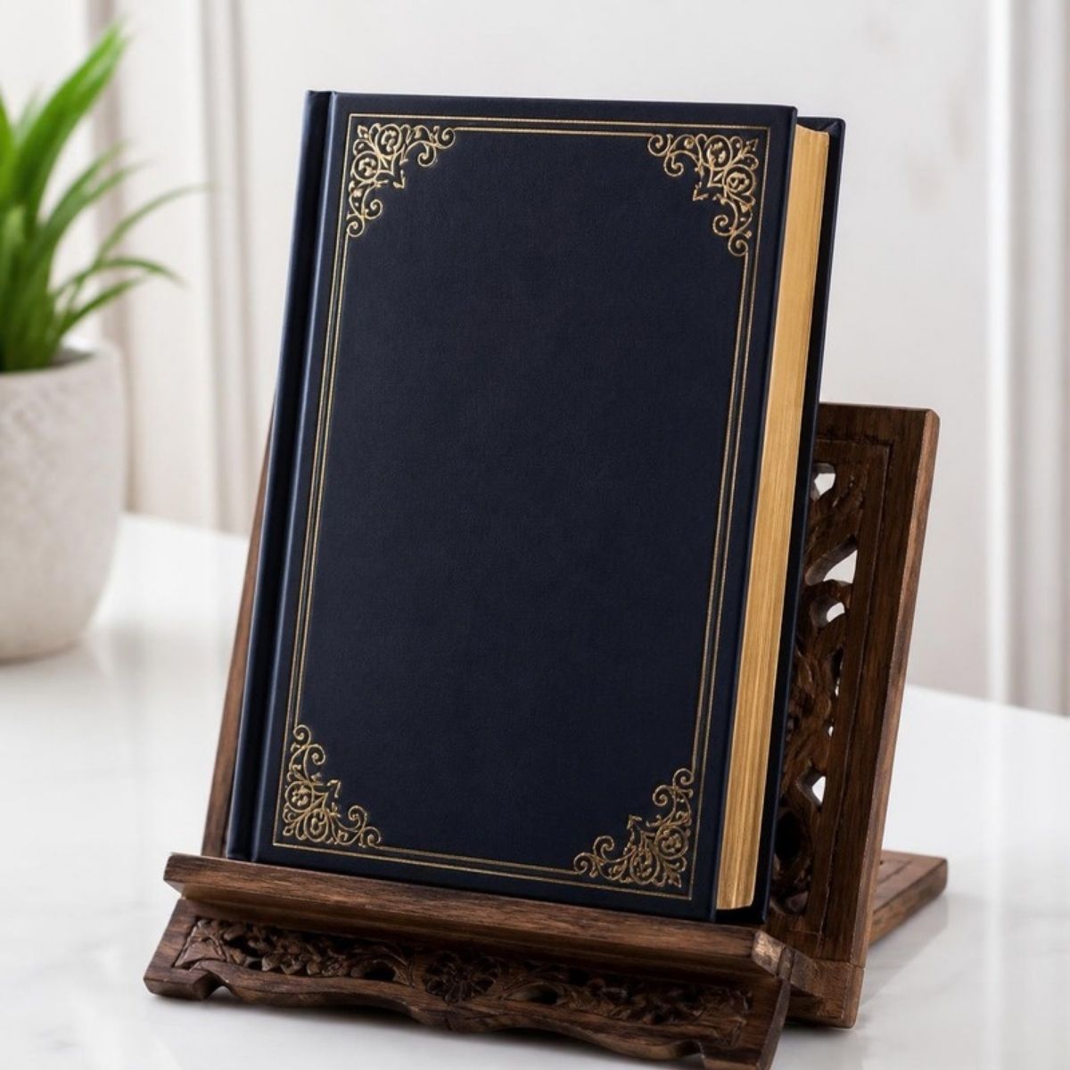 Closed dark book with a gold ornate frame on the cover, on a carved wooden stand