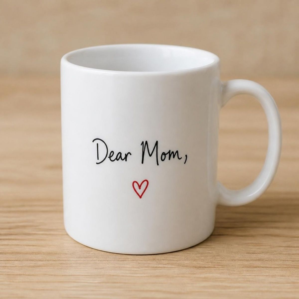 White coffee mug reading "Dear Mom," with a small red heart