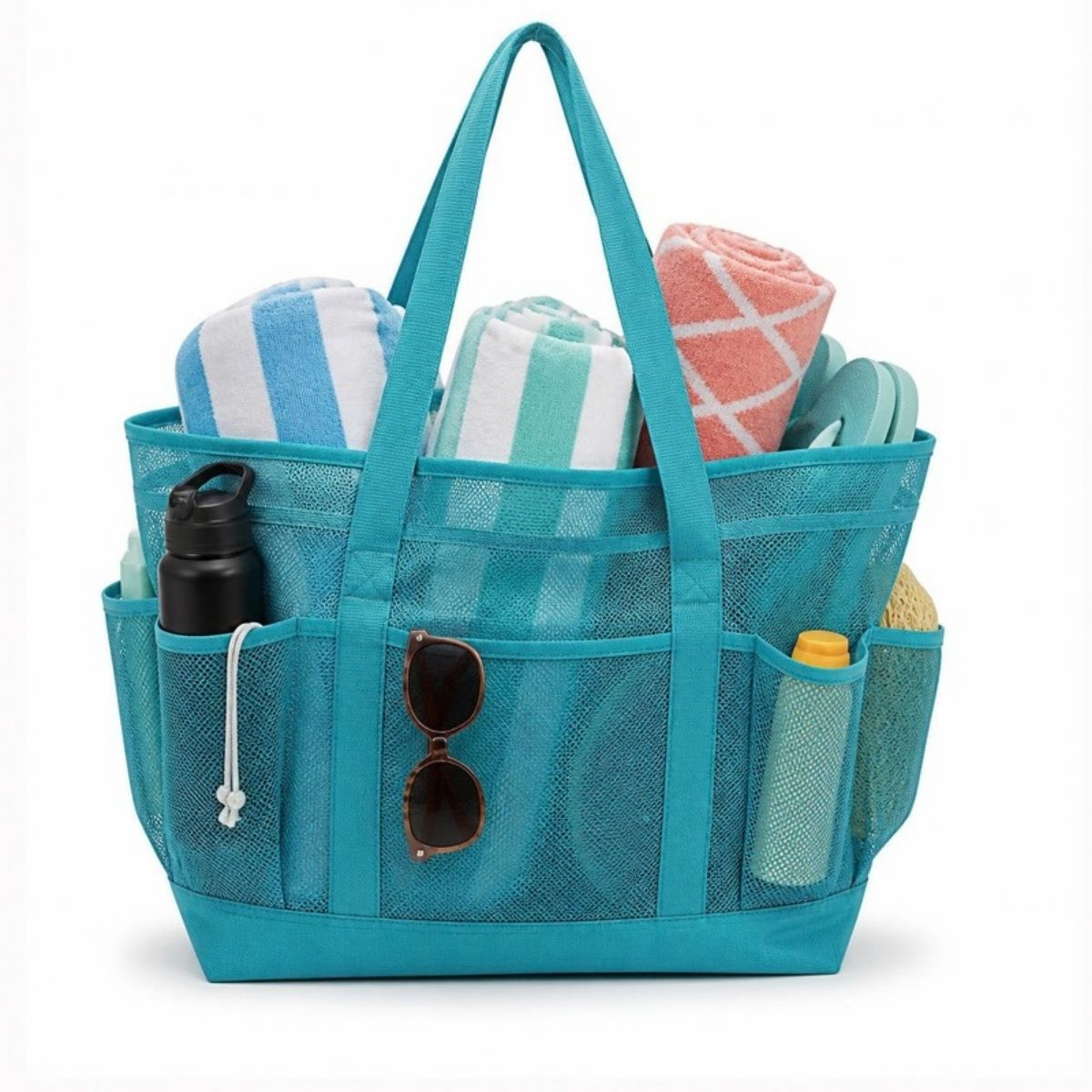 Teal mesh beach tote with outside pockets, full of rolled towels, a water bottle and sunglasses