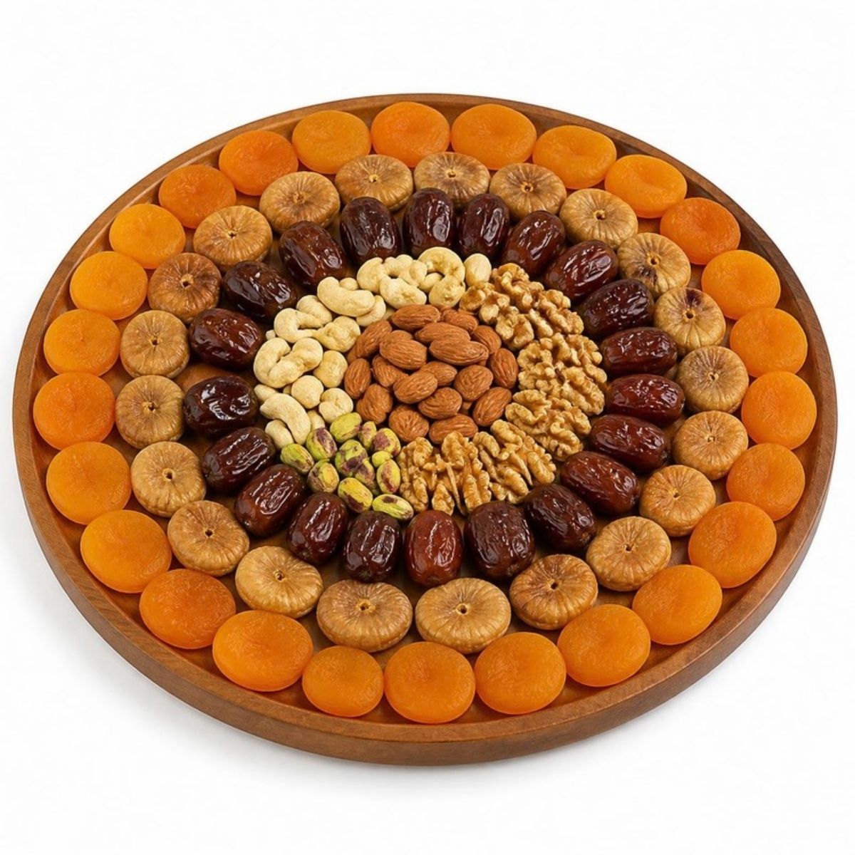 Round wooden tray of dried apricots, dates and mixed nuts arranged in rings