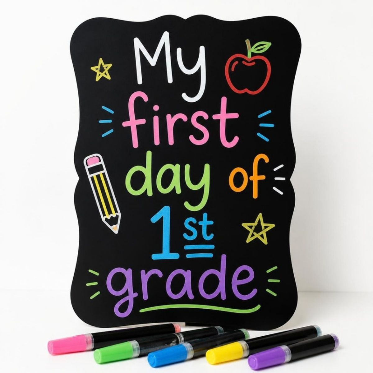 Black chalkboard sign reading "My first day of 1st grade" in colorful letters with chalk markers