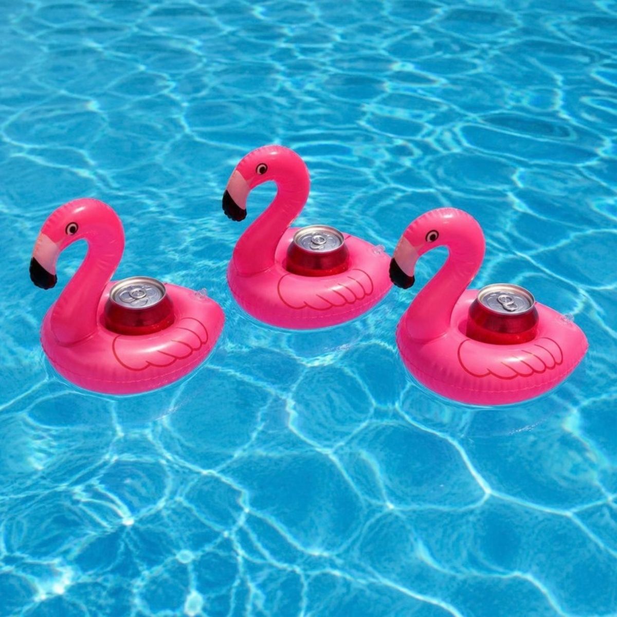 Three pink inflatable flamingo drink holders