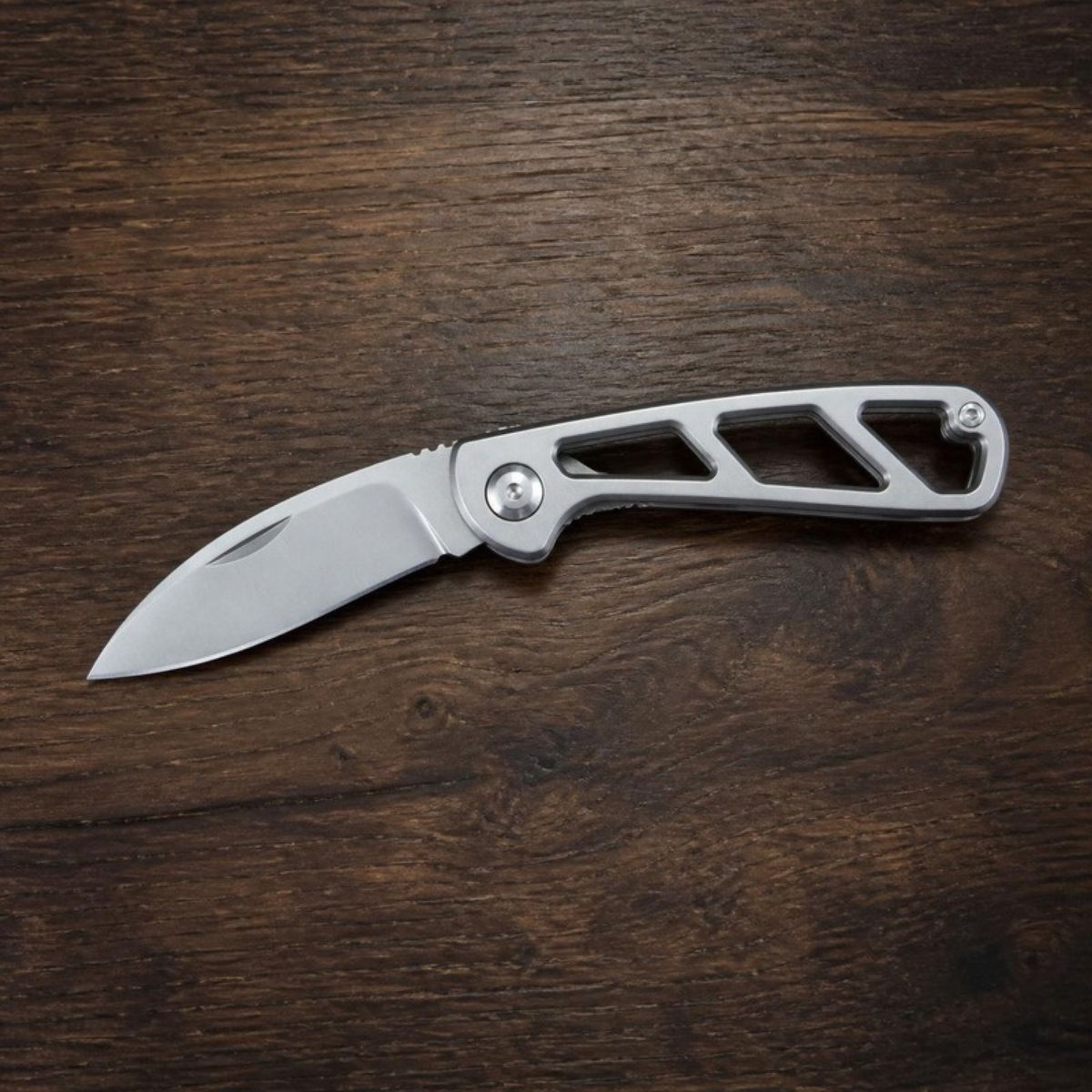 Silver folding pocket knife with an open frame handle