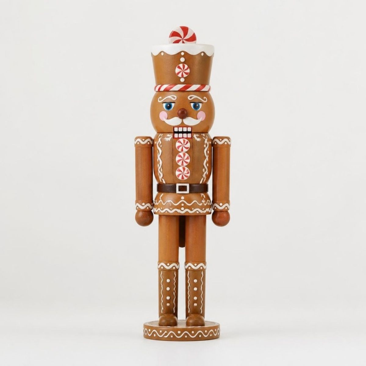 Wooden gingerbread nutcracker with peppermint candy details