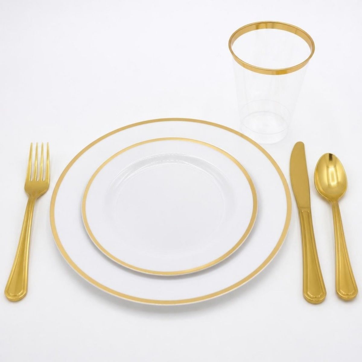 Plastic plates with gold rims, gold cutlery and a gold-rimmed cup