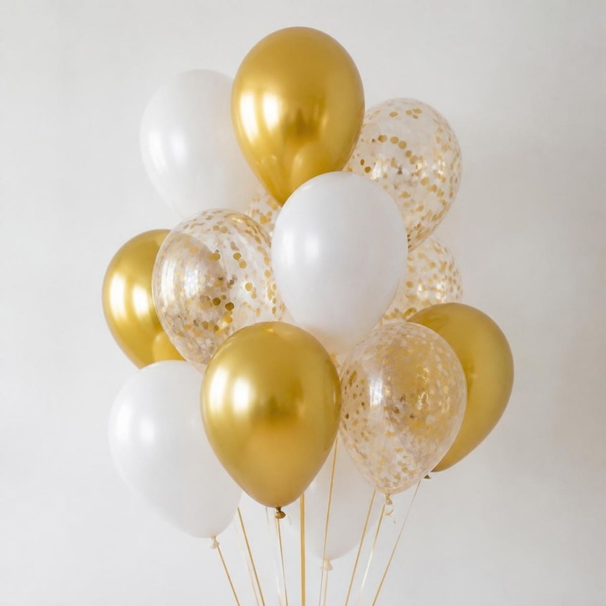 Bunch of gold, white and confetti balloons