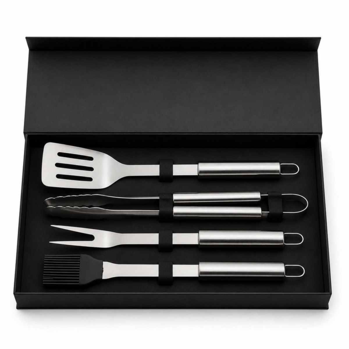 Stainless steel spatula, tongs, fork and basting brush in a black gift box