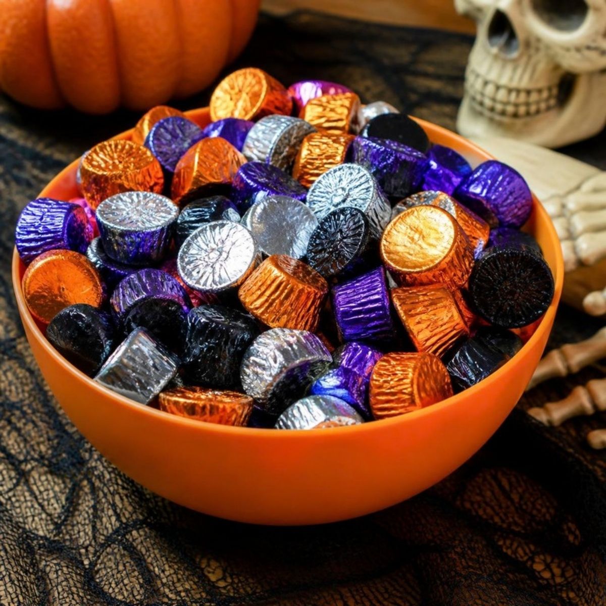 Orange bowl of chocolates in orange, purple, black and silver foil