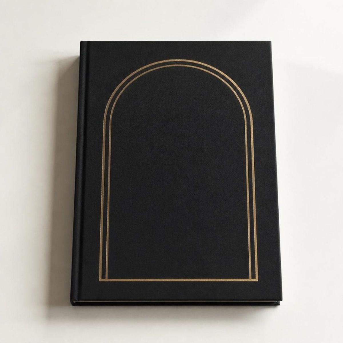Black hardcover book with a gold arch design on the cover