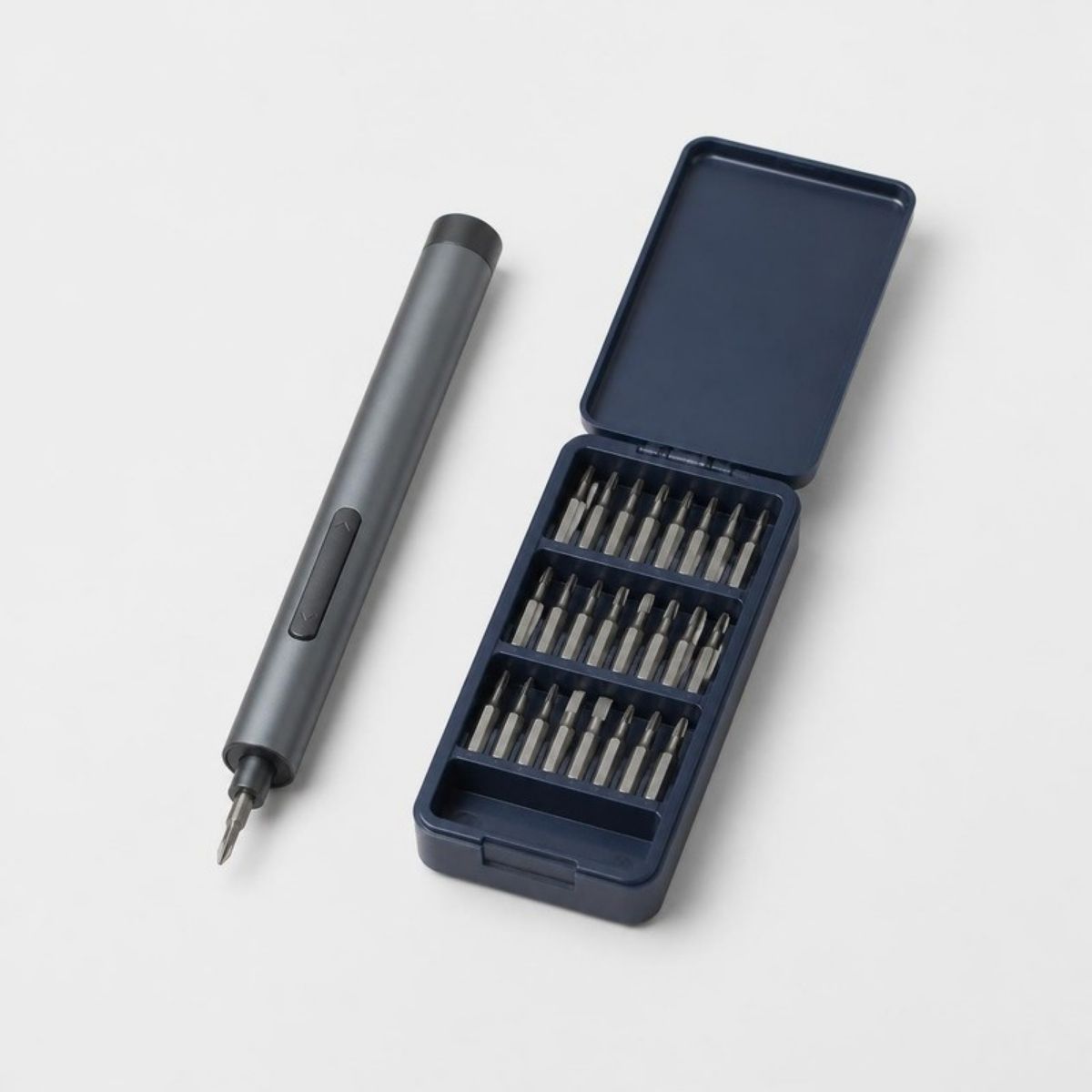 Slim gray electric screwdriver with bits in a navy case