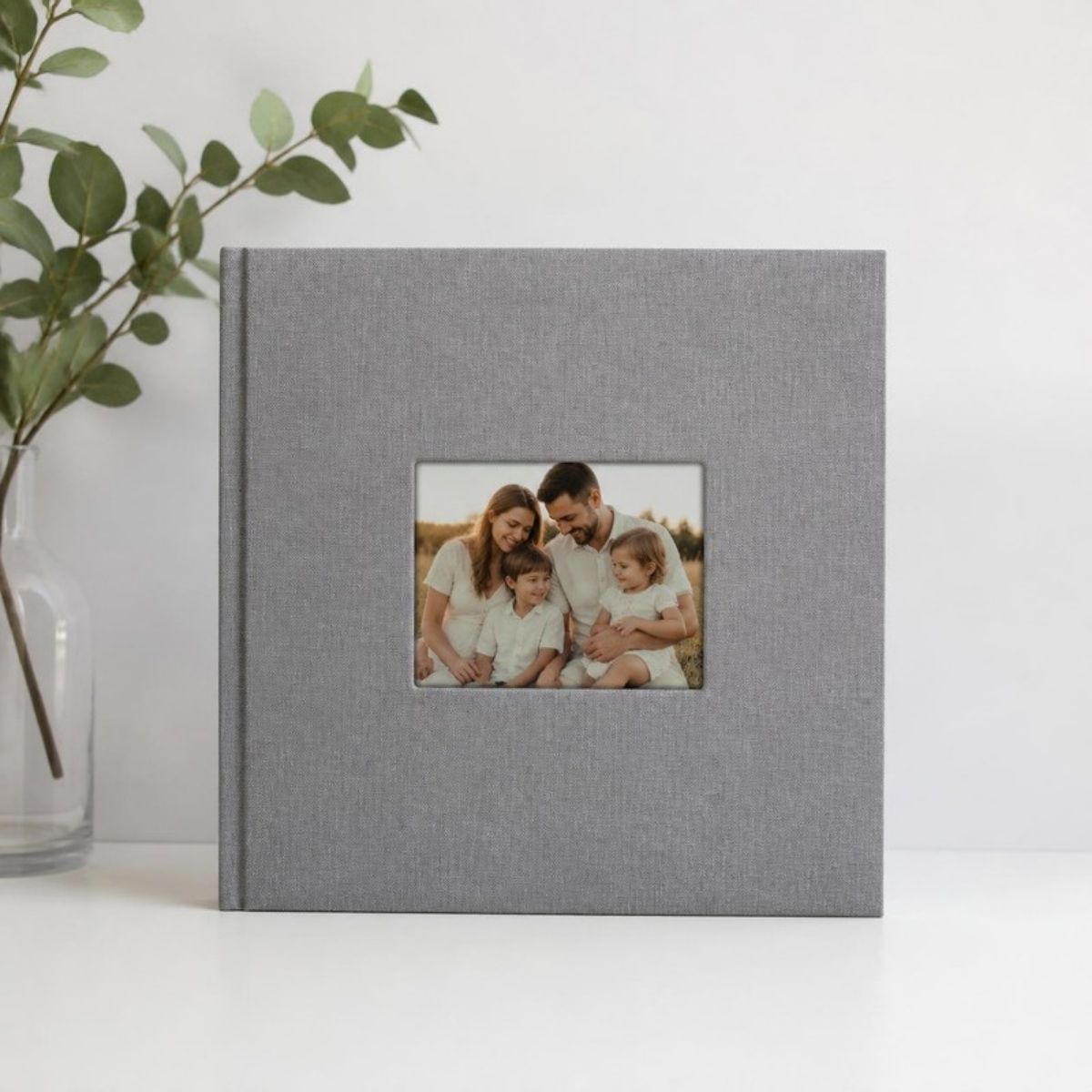 Gray linen photo album with a family photo in the cover window