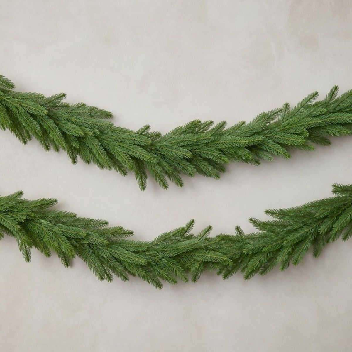 Two strands of green Norfolk pine garland