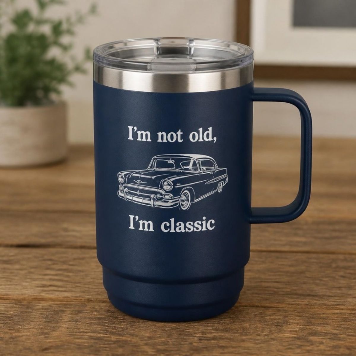 Navy insulated mug with a handle, with a classic car and "I'm not old, I'm classic"