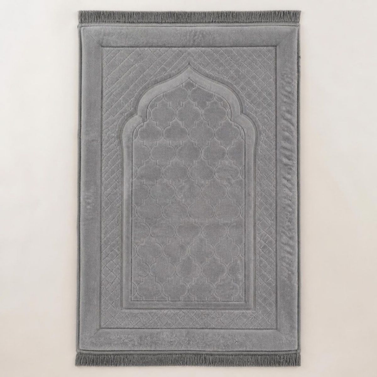Gray patterned padded prayer rug with a mosque arch design