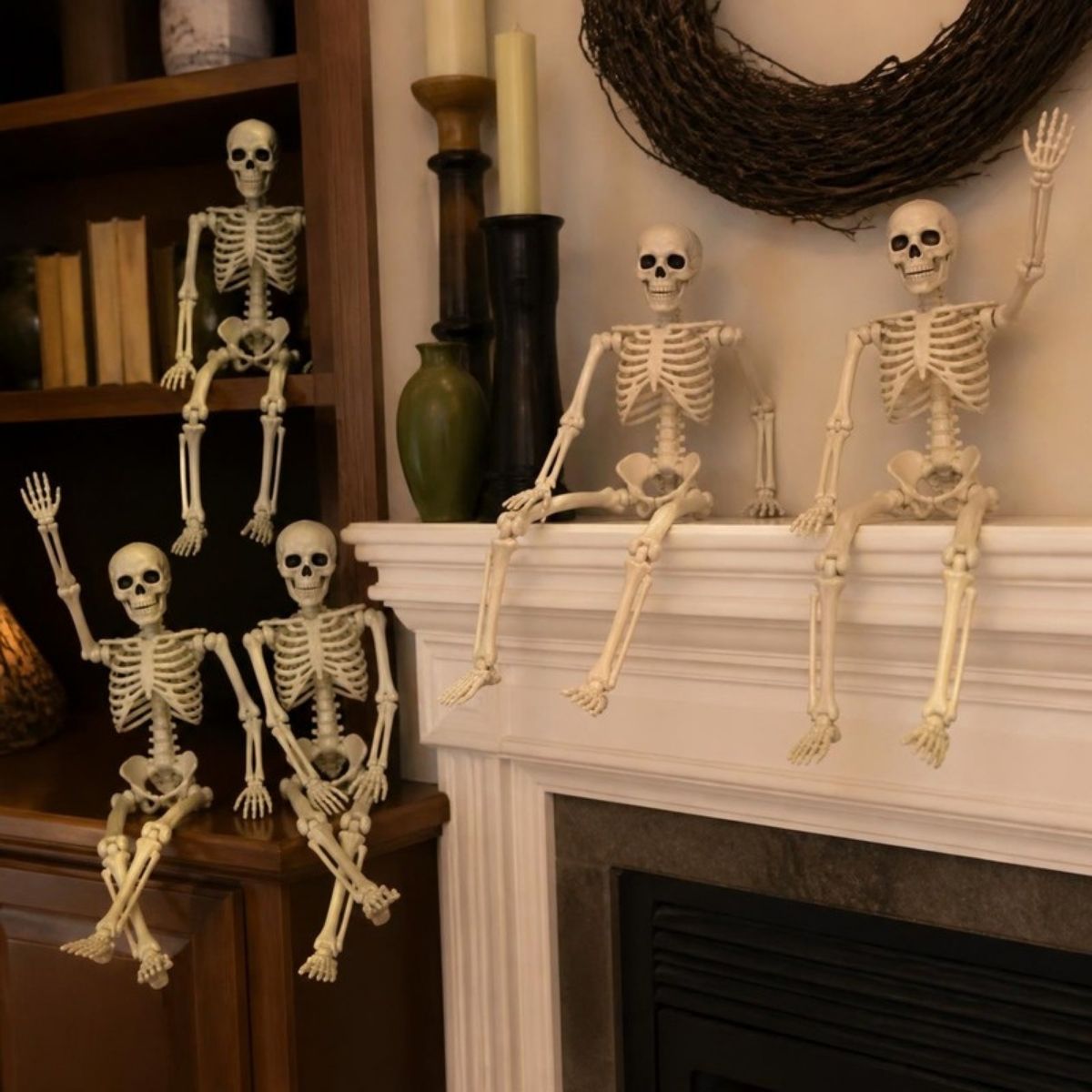 Small posable skeletons sitting and waving on a mantel and shelf