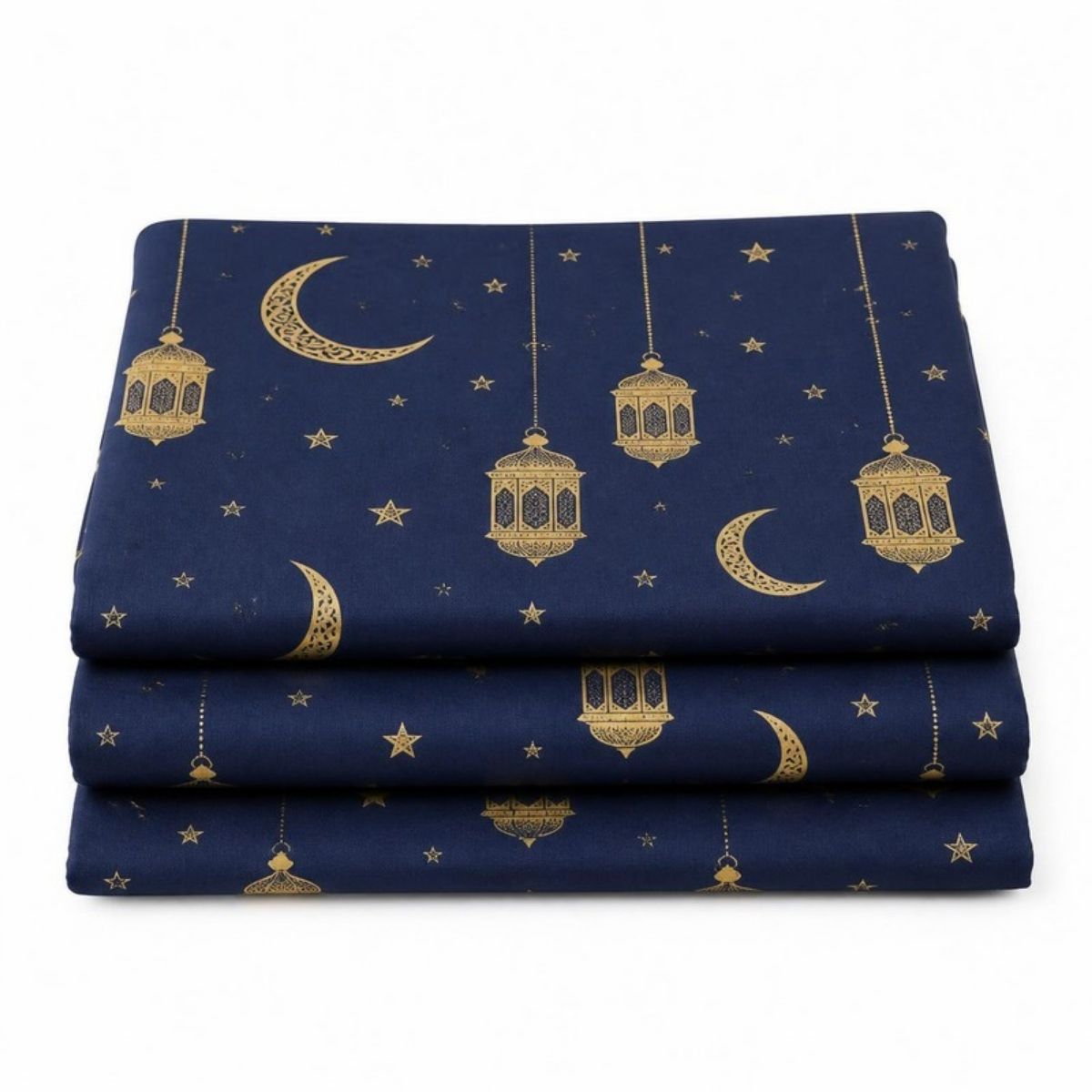 Three folded navy blue tablecloths with gold moons, stars and lanterns