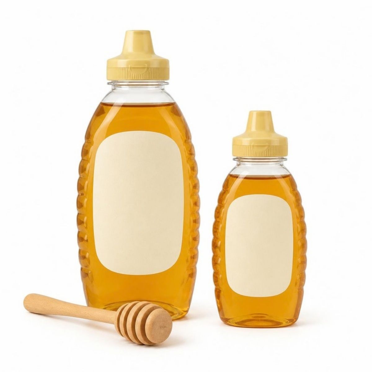 Two squeeze bottles of golden honey with a honey dipper