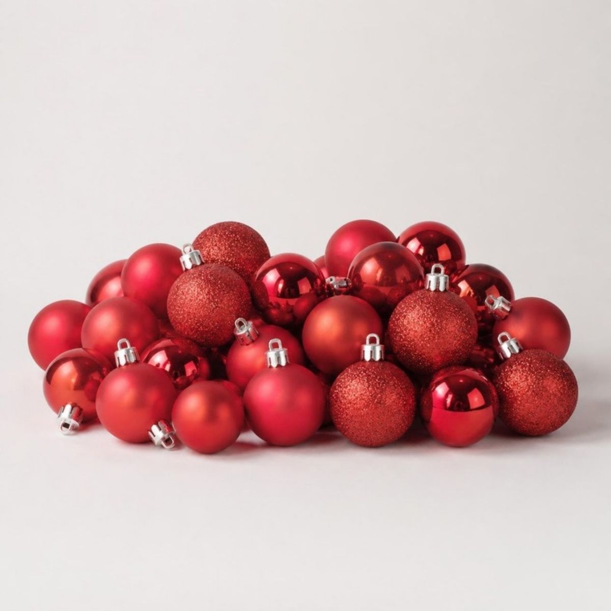 Pile of shiny, matte and glitter red ball ornaments