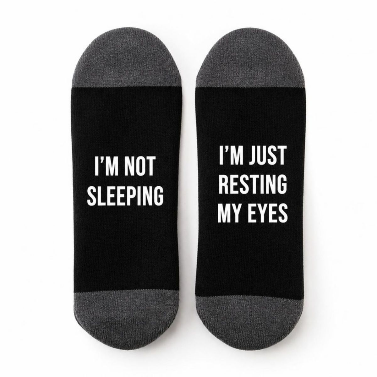 Black socks with gray heels reading "I'm not sleeping" and "I'm just resting my eyes"