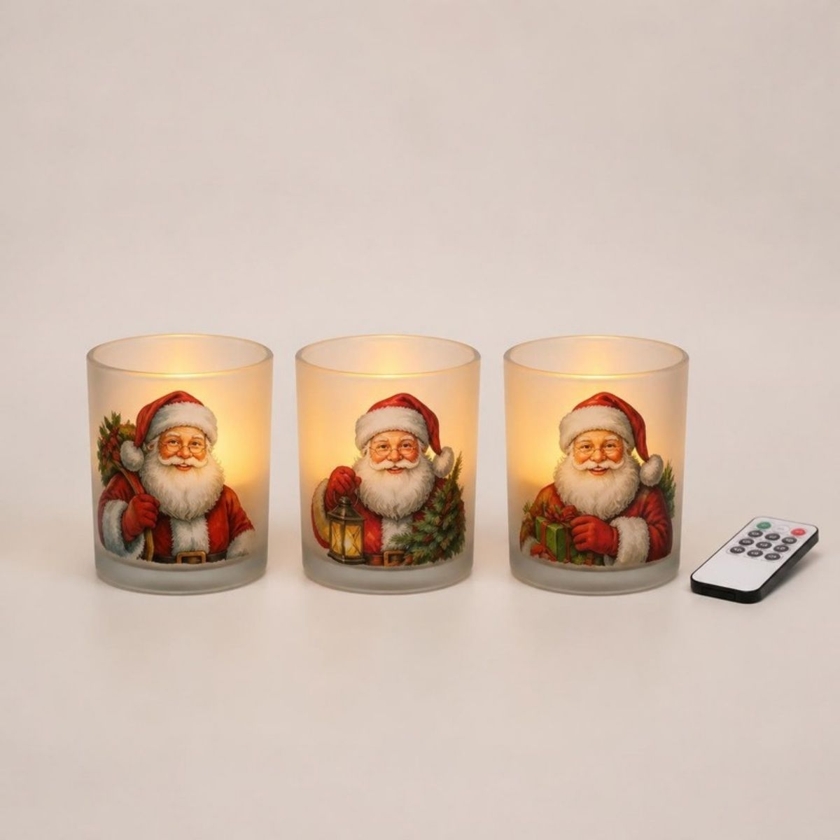 Three frosted glass flameless candles printed with Santa Claus, with a remote