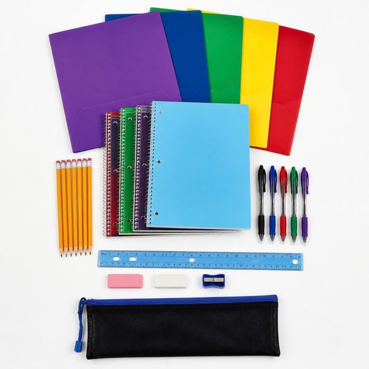 School supplies laid out: folders, spiral notebooks, pencils, pens, ruler, erasers, sharpener and a pencil pouch
