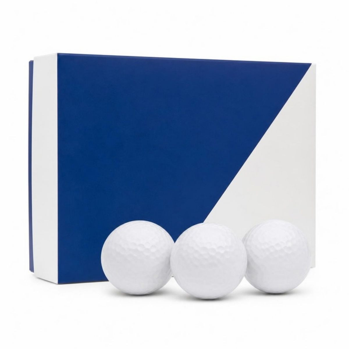 Blue and white box of golf balls with three white balls in front